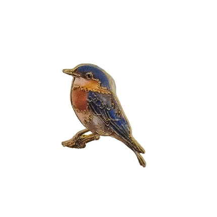 bird pin badge with a white stone on a white background