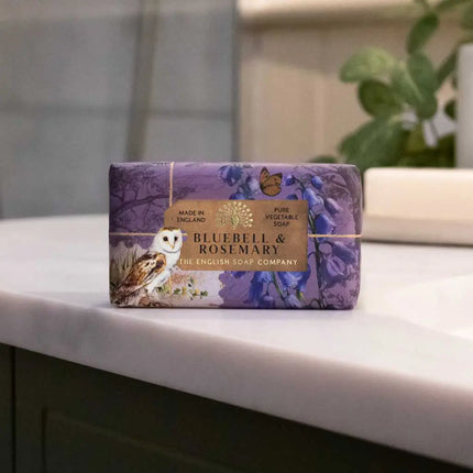 Purple soap bar with 'Bluebell & Rosemary' packaging on a bathroom counter.
