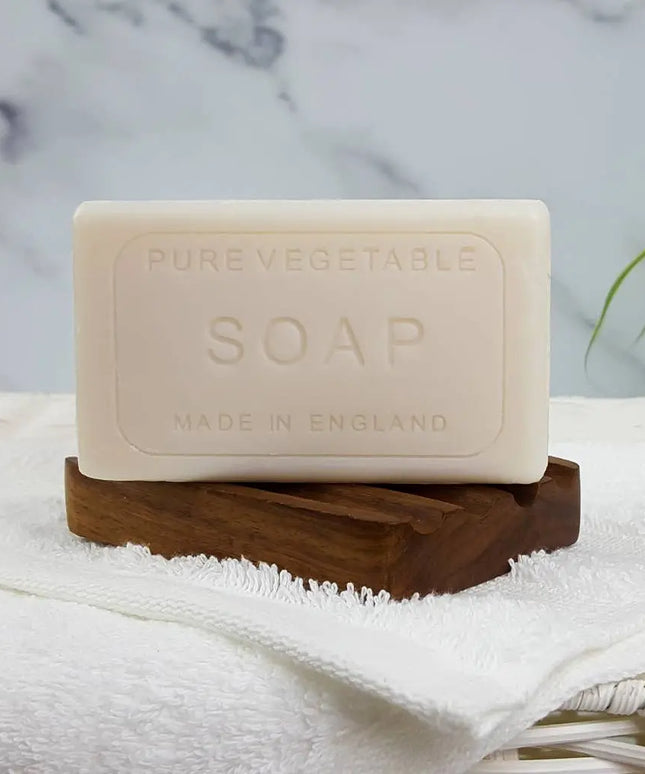 Bar of pure vegetable soap on a wooden stand with a marble background