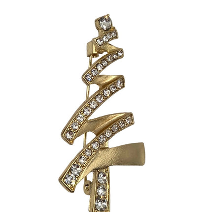 A gold Christmas tree-shaped brooch embellished with clear rhinestones, shown on a light gray background.