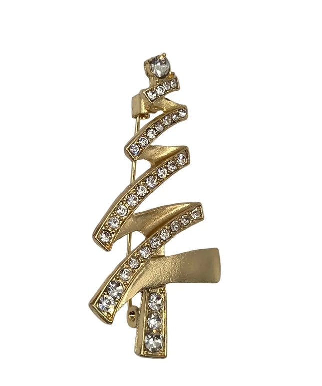 A gold Christmas tree-shaped brooch embellished with clear rhinestones, shown on a light gray background.