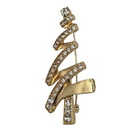 A gold Christmas tree-shaped brooch decorated with clear rhinestones, set against a plain light gray background.