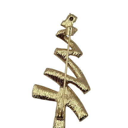 A gold Christmas tree-shaped brooch with a textured finish and a pin back, shown on a plain light gray background.