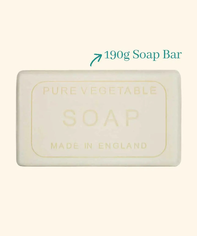 Bar of soap labeled 'Pure Vegetable Soap Made in England' with a weight indication on a beige background.